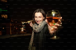 a woman holding a glass of wine in her hand