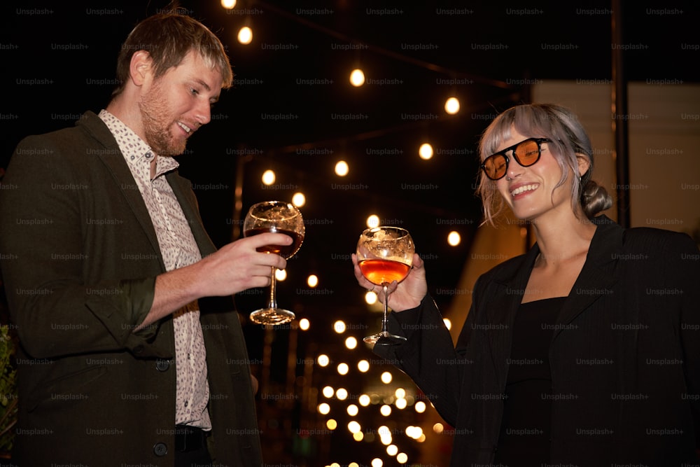 a man and a woman holding glasses of wine