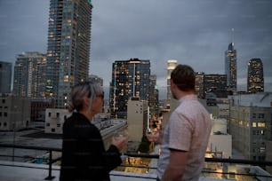 a couple of people standing on top of a building