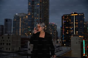 a woman standing on top of a roof talking on a cell phone