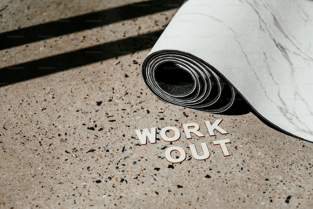 a yoga mat with the word work out written on it