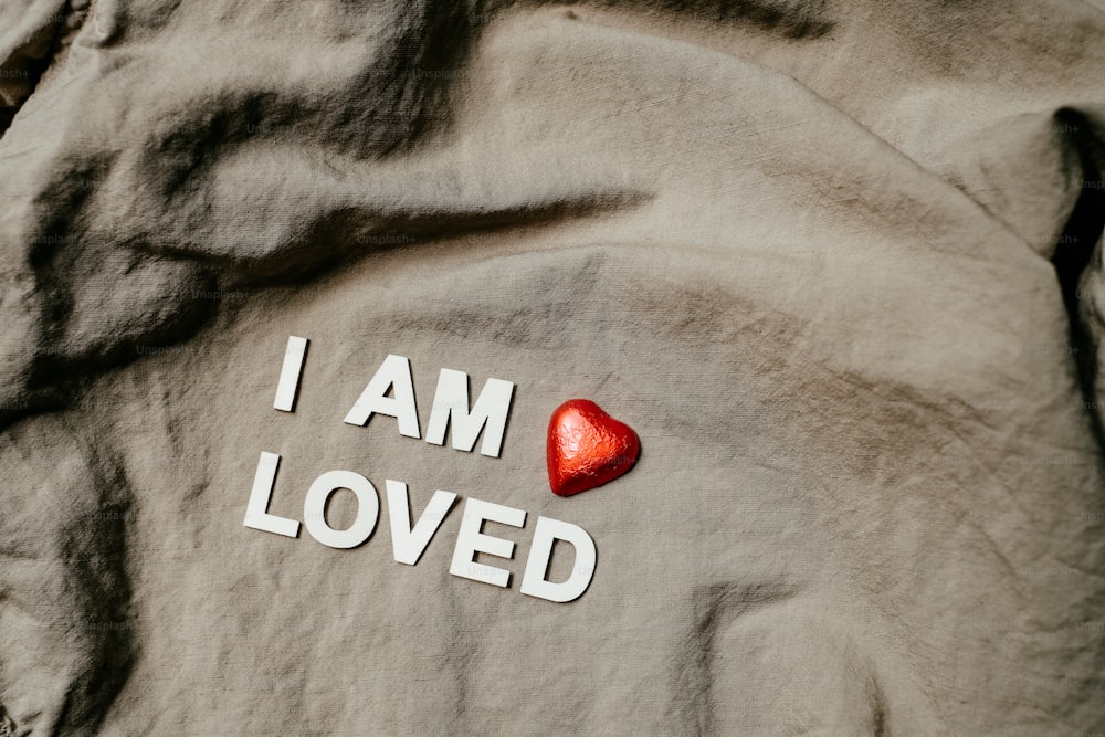 i am loved written on a shirt with a heart