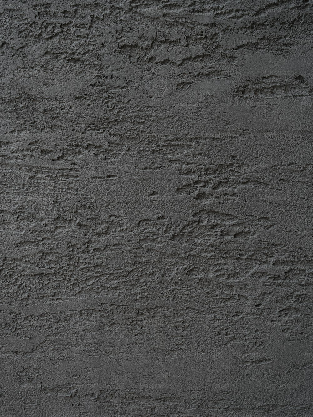 uma foto em preto e branco de uma parede de concreto