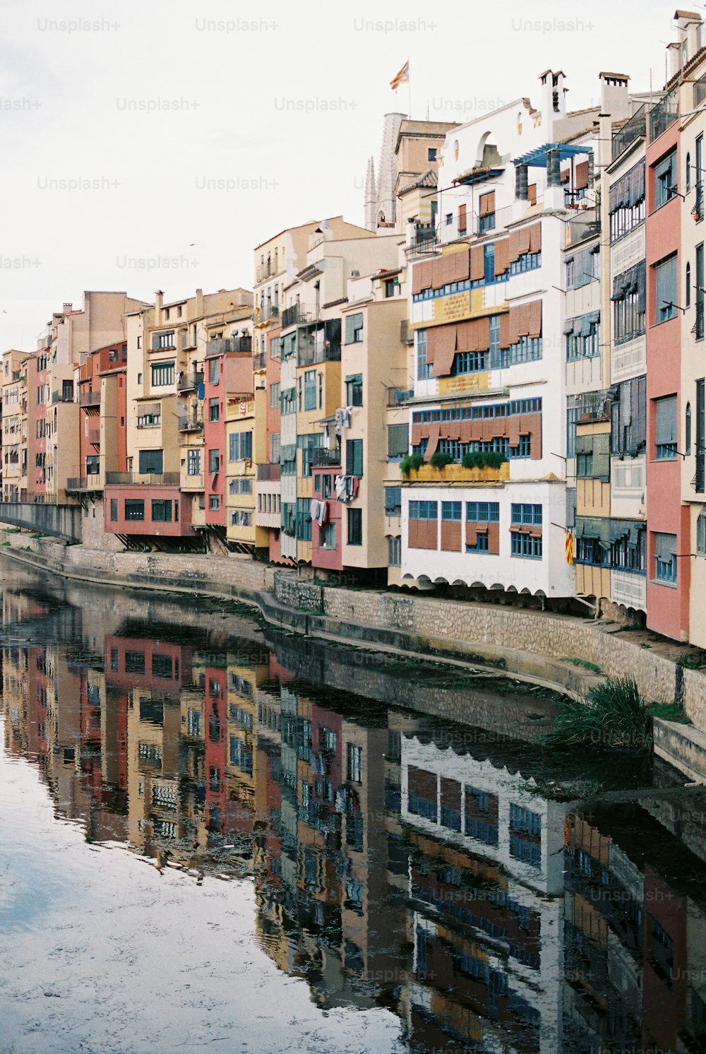 a river running through a city next to tall buildings