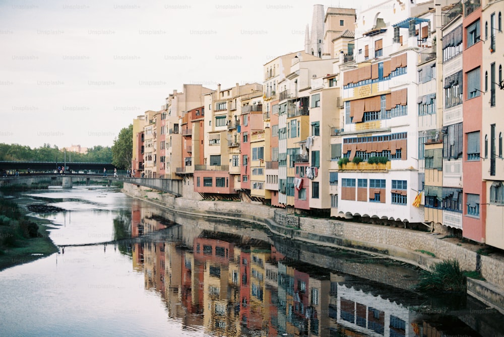 a river running through a city next to tall buildings