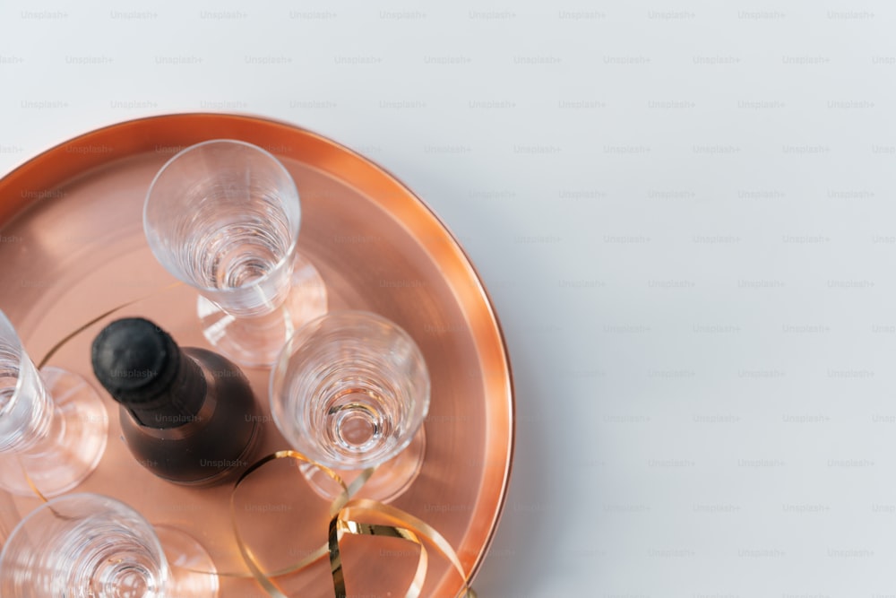 a metal tray with wine glasses and a bottle of wine