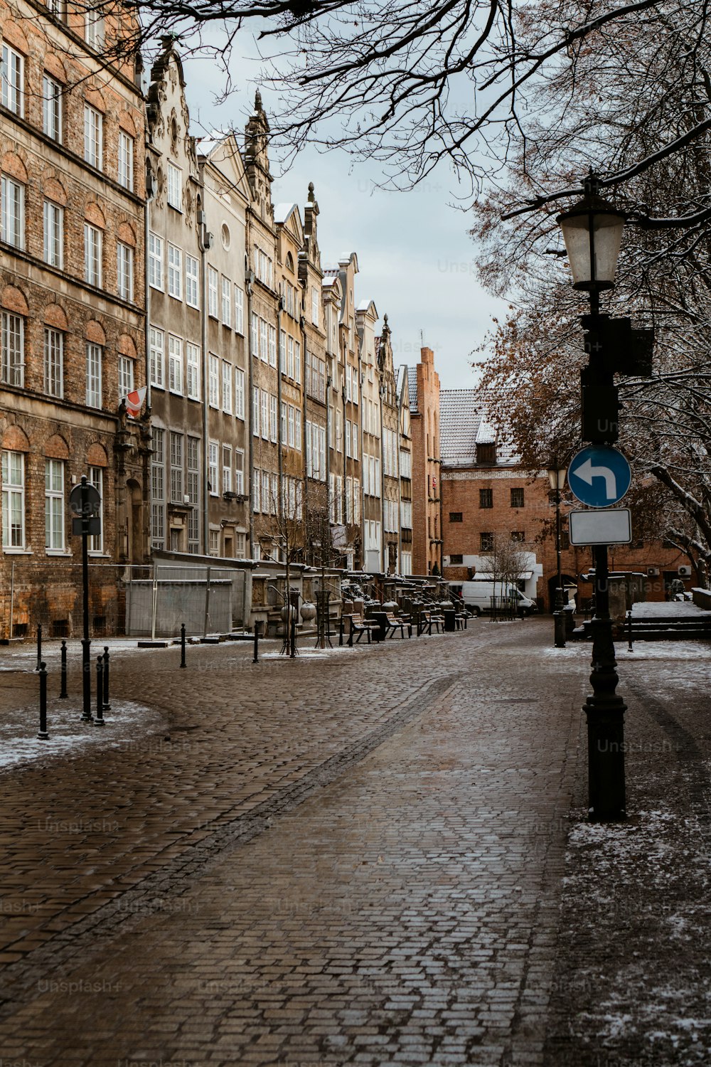 a cobblestone street lined with tall brick buildings