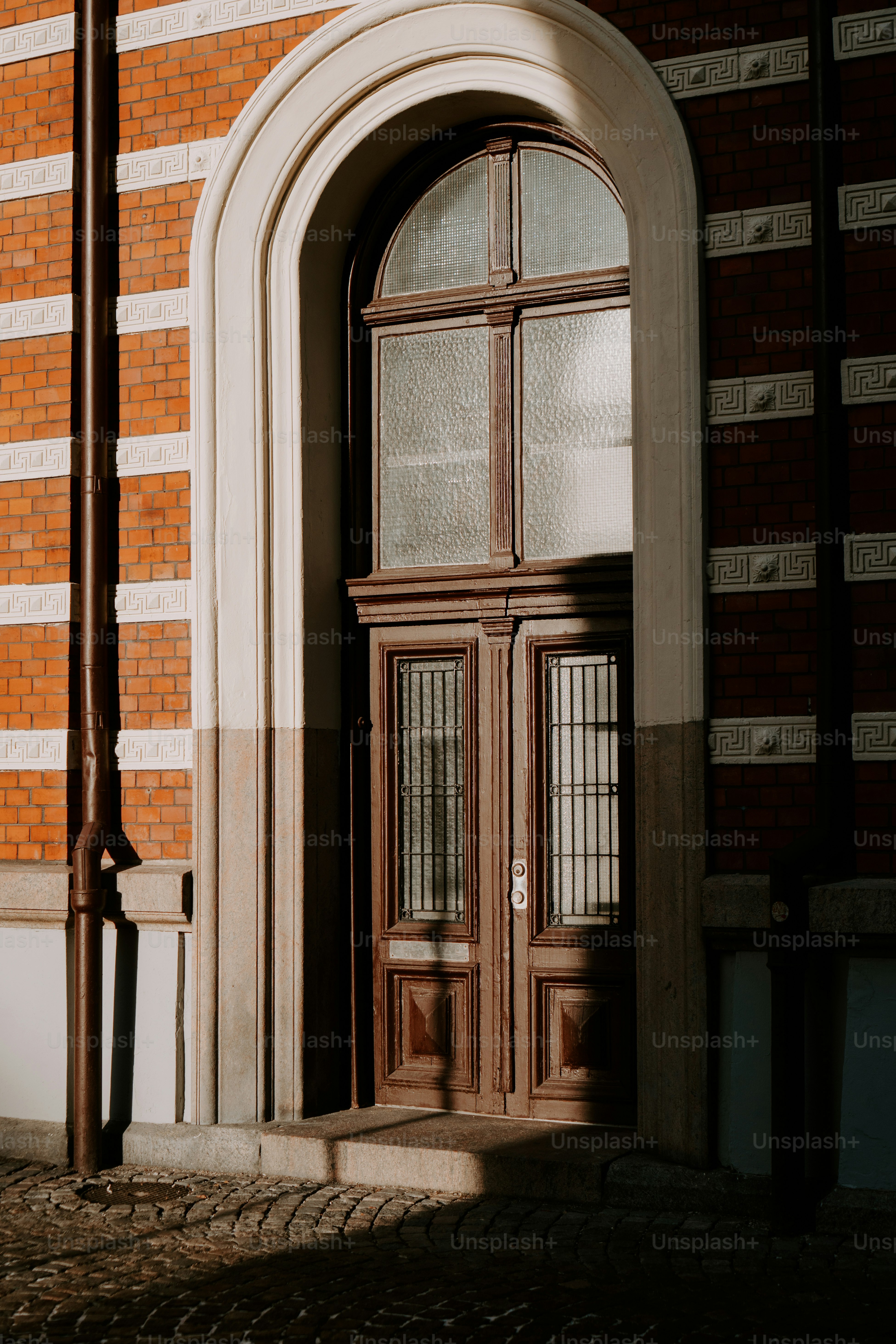 a building with a large wooden door and arched window