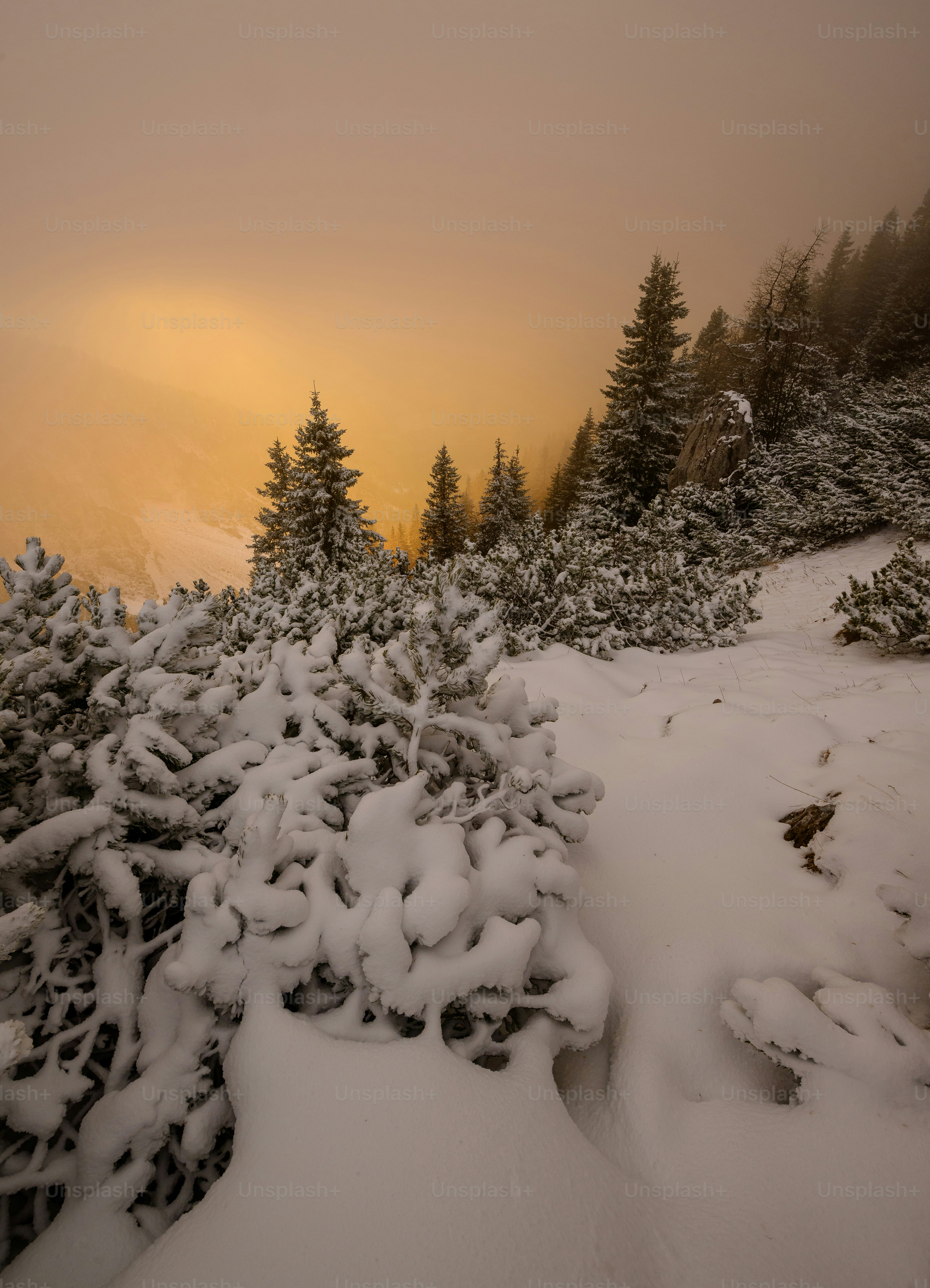 The sun is setting on a snowy mountain photo – Winter Image on Unsplash