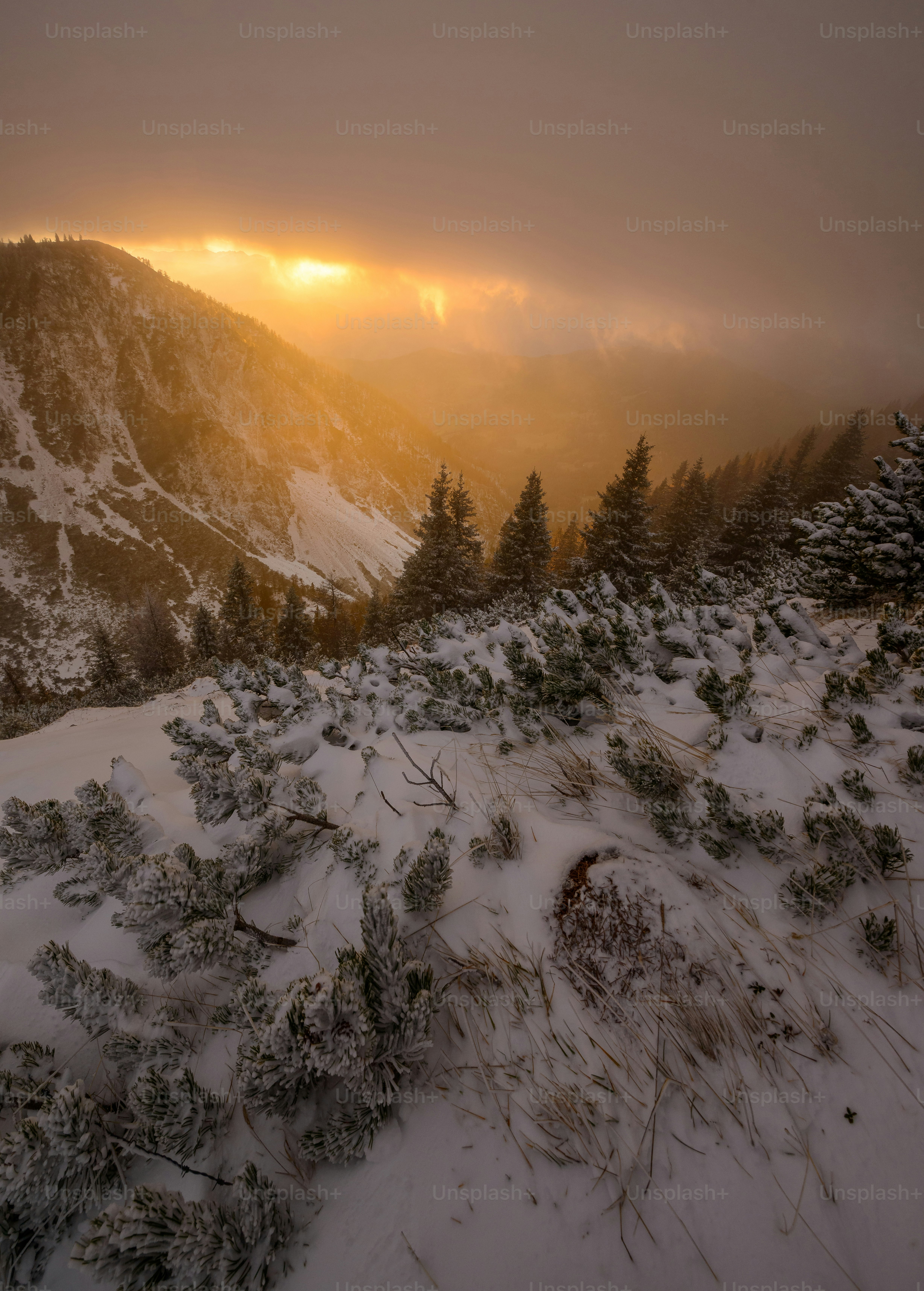 The sun is setting on a snowy mountain photo – Winter Image on Unsplash