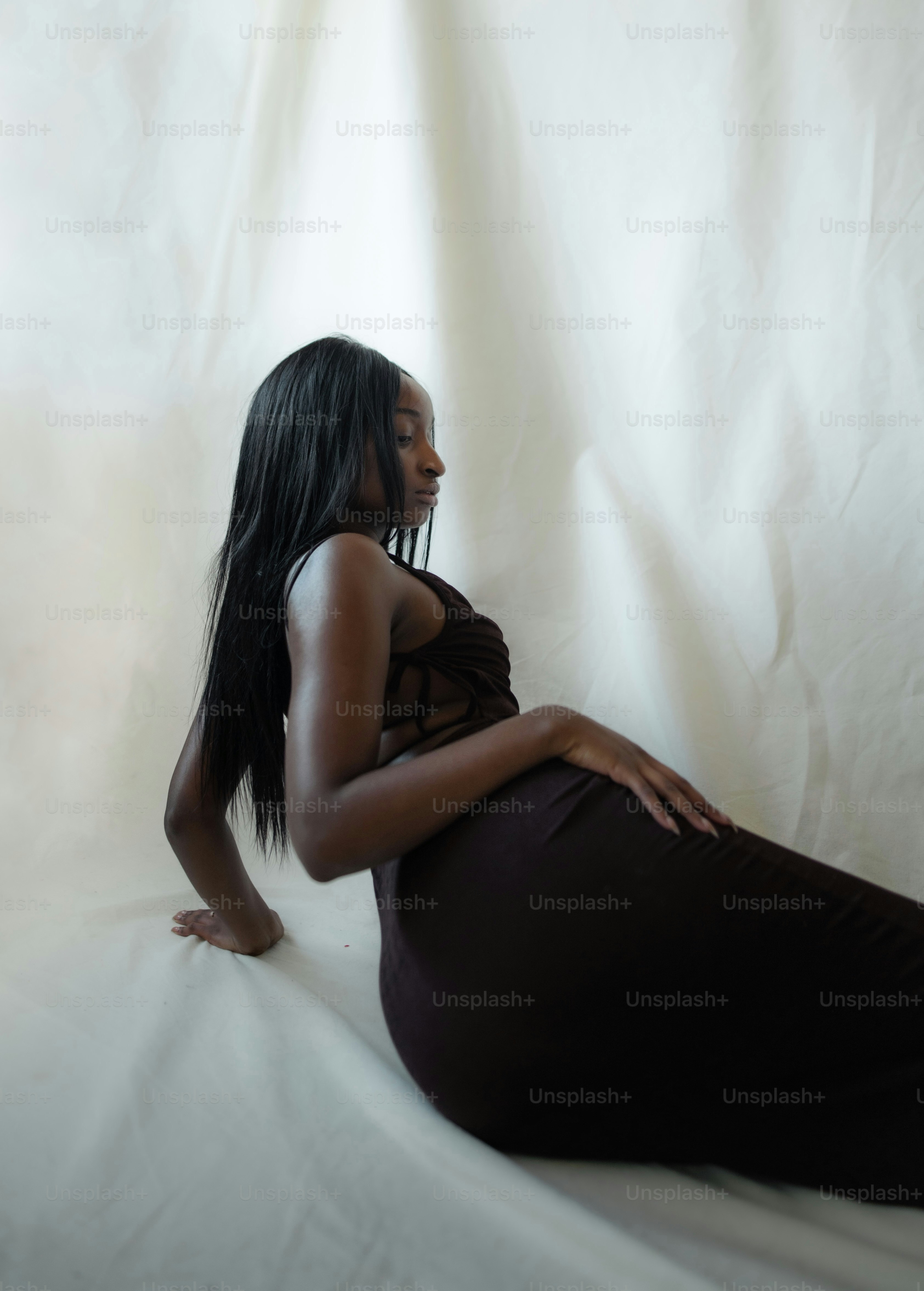 A woman standing in a dark room with her back to the camera photo ...