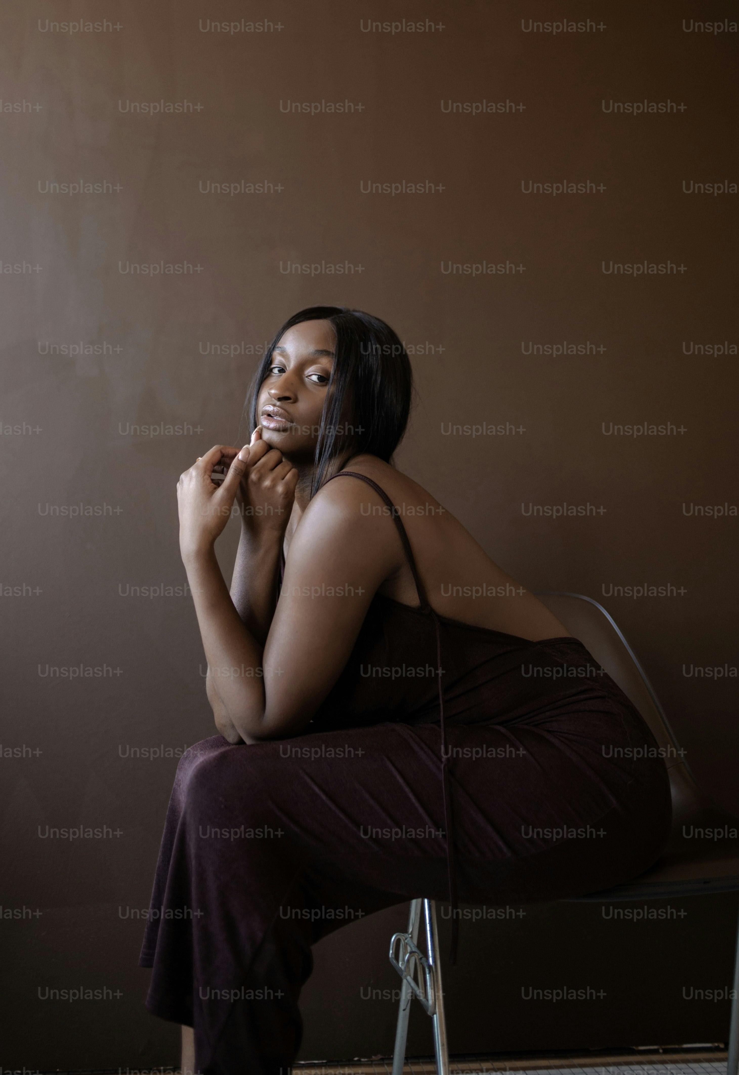 A woman standing in a dark room with her back to the camera photo ...