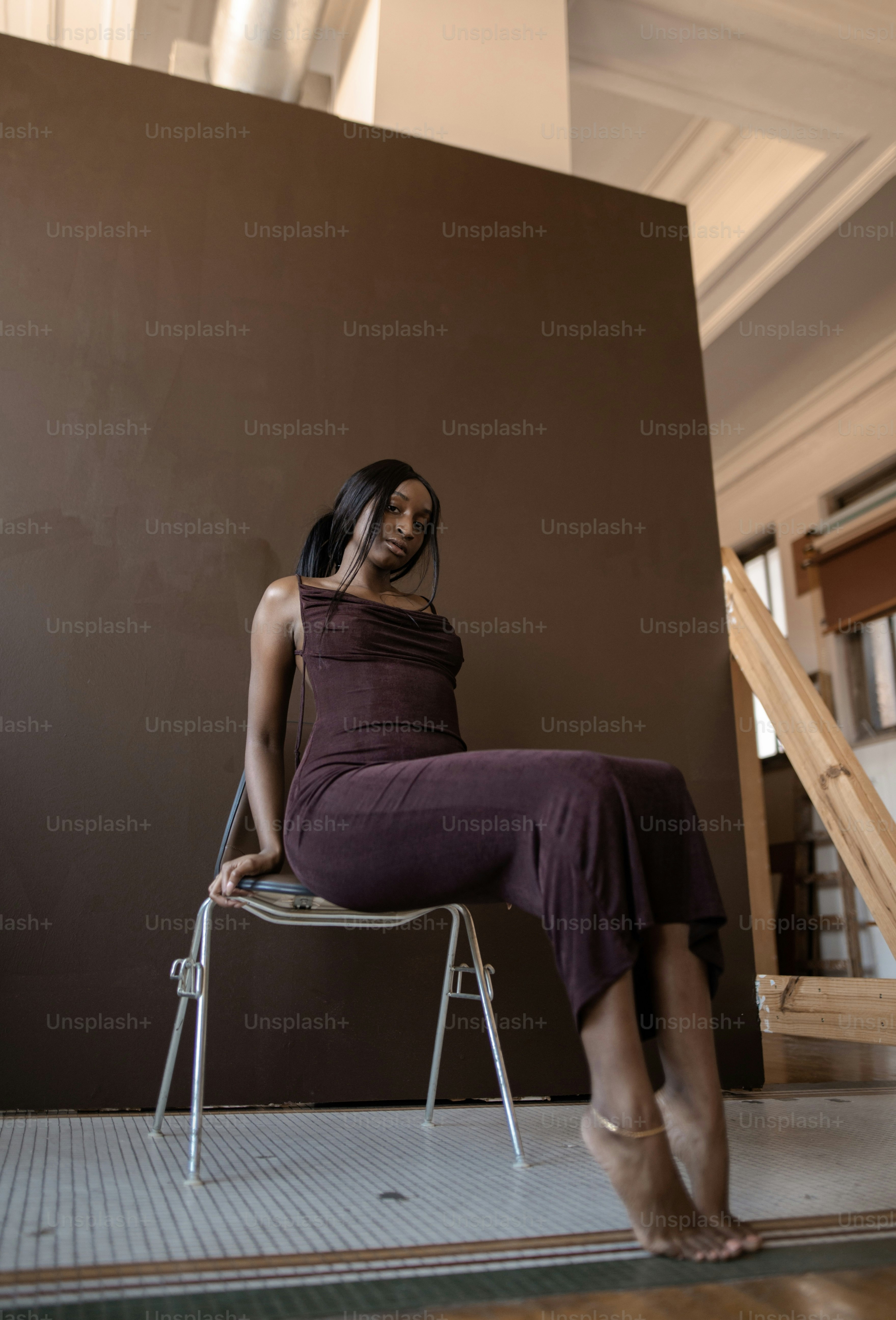 A woman standing in a dark room with her back to the camera photo ...