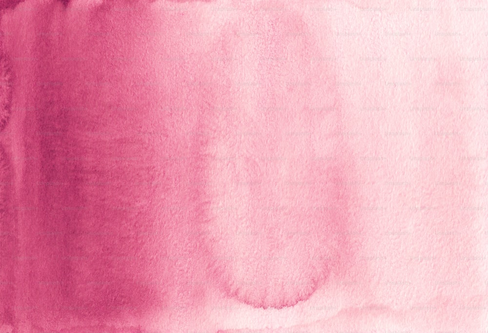 a close up of a pink watercolor background