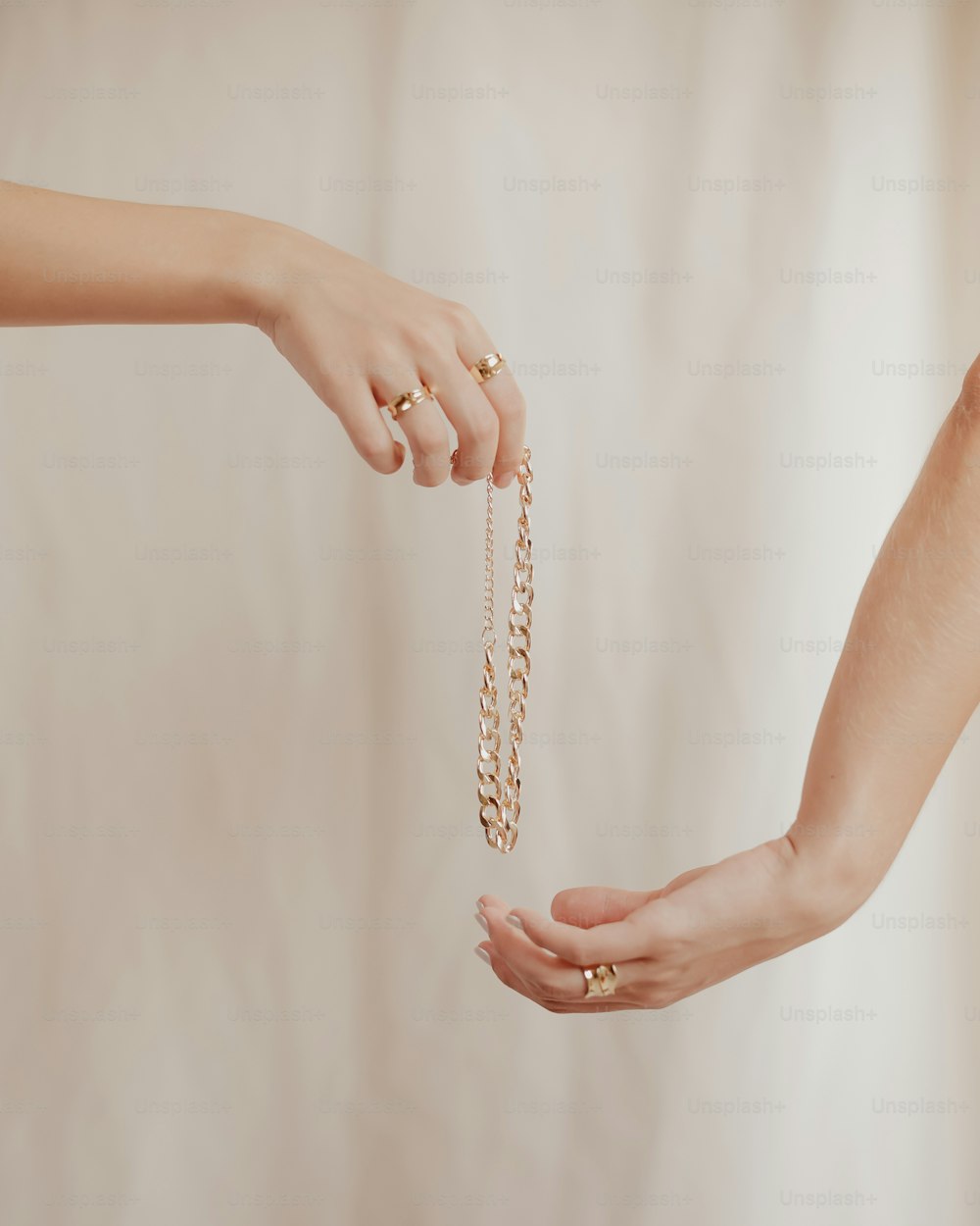 a woman holding a chain with her hands