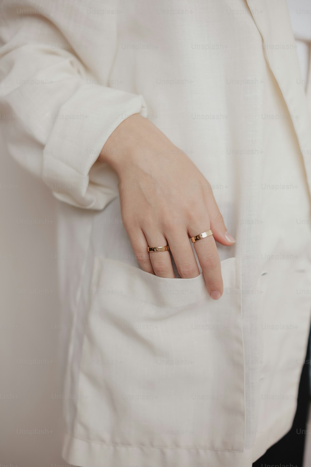 a woman wearing a white shirt and a gold ring