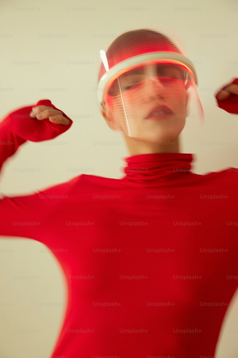 a woman in a red dress with a futuristic headpiece