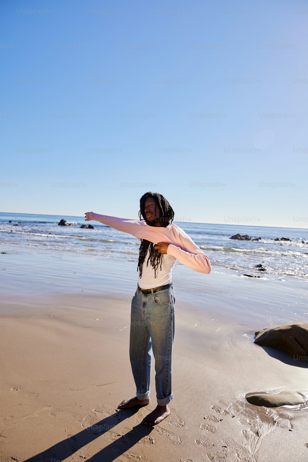 a woman standing on top of a sandy beach