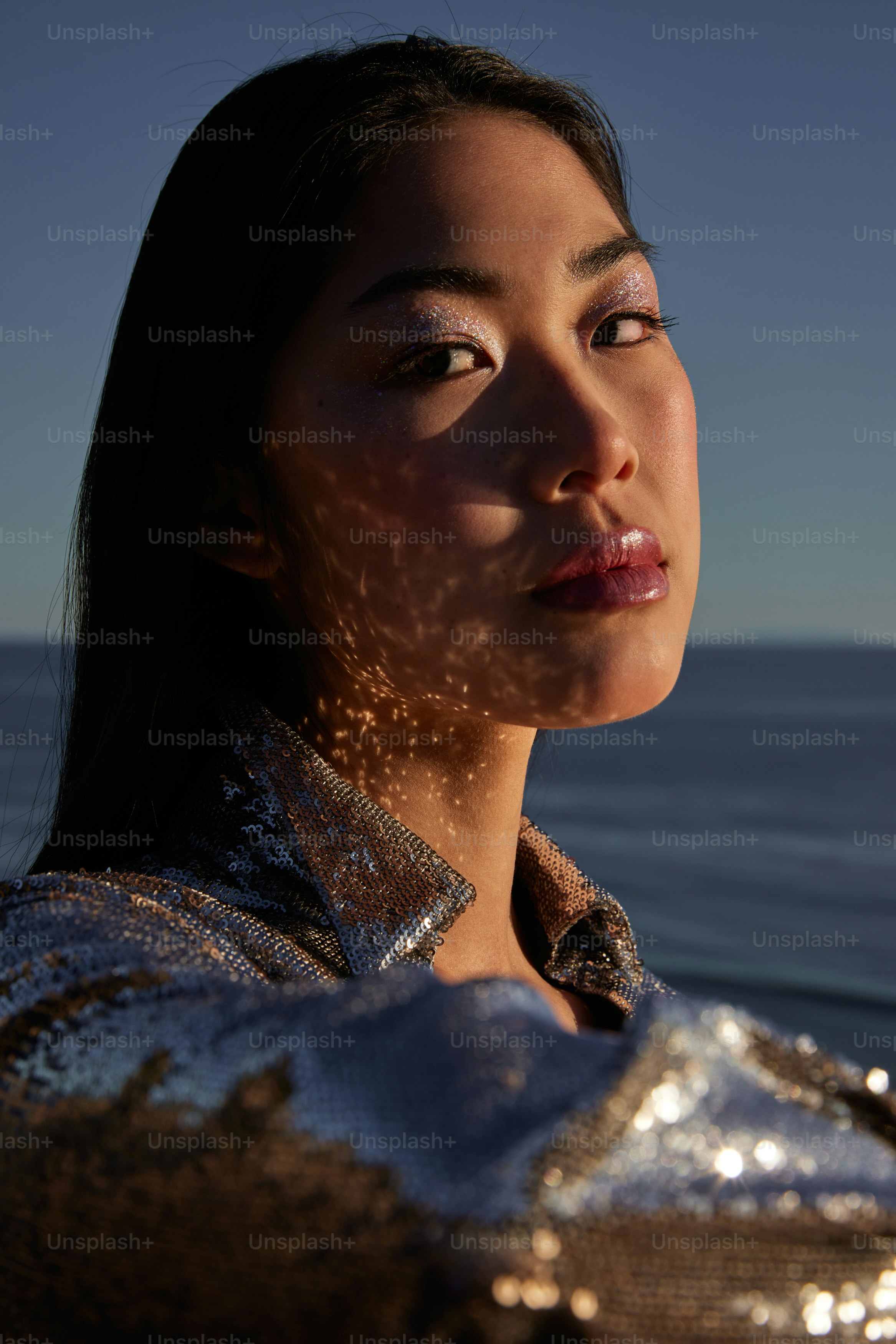 A woman standing in front of a body of water photo – Mermaids Image on ...