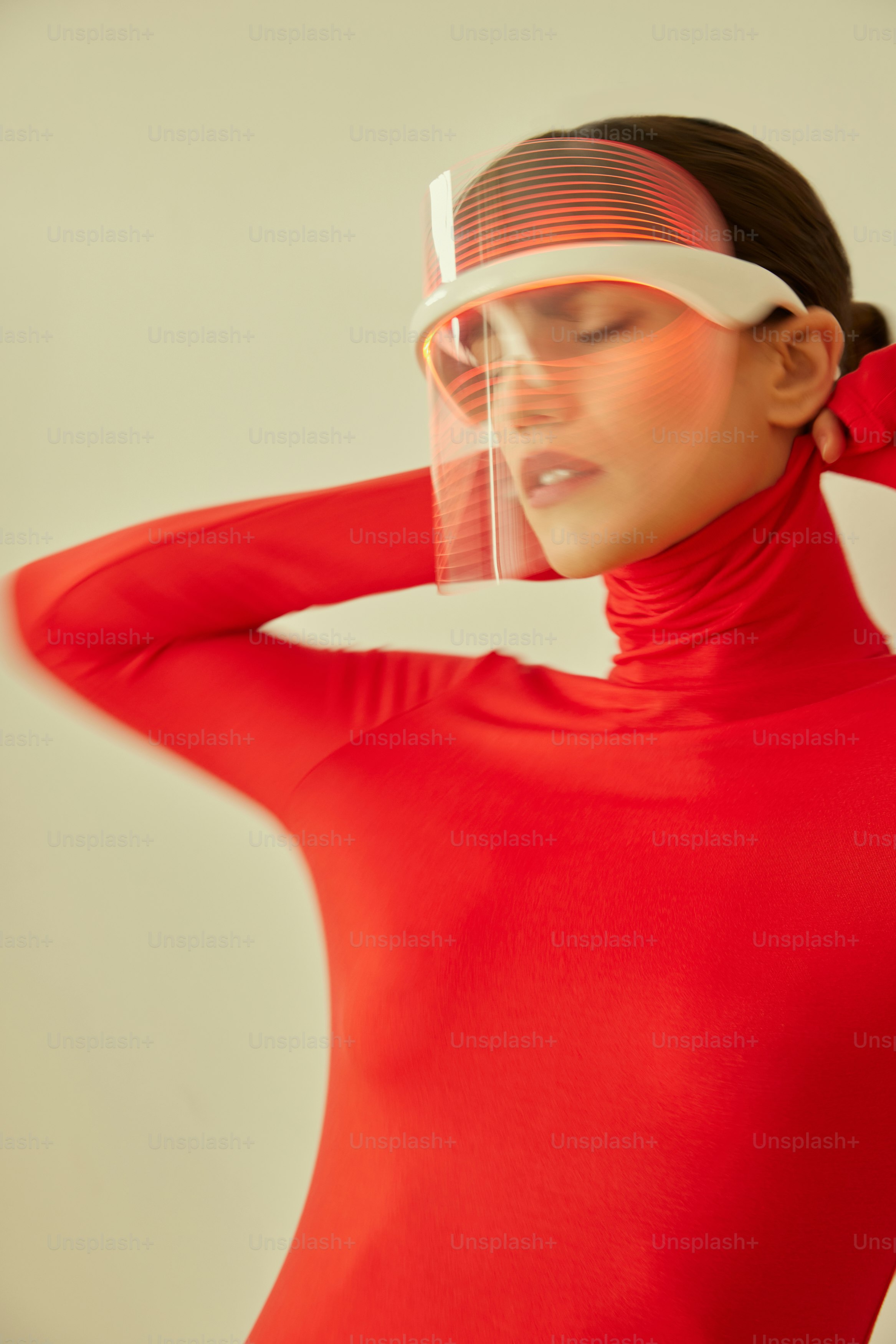 a woman in a red dress with a visor on her head