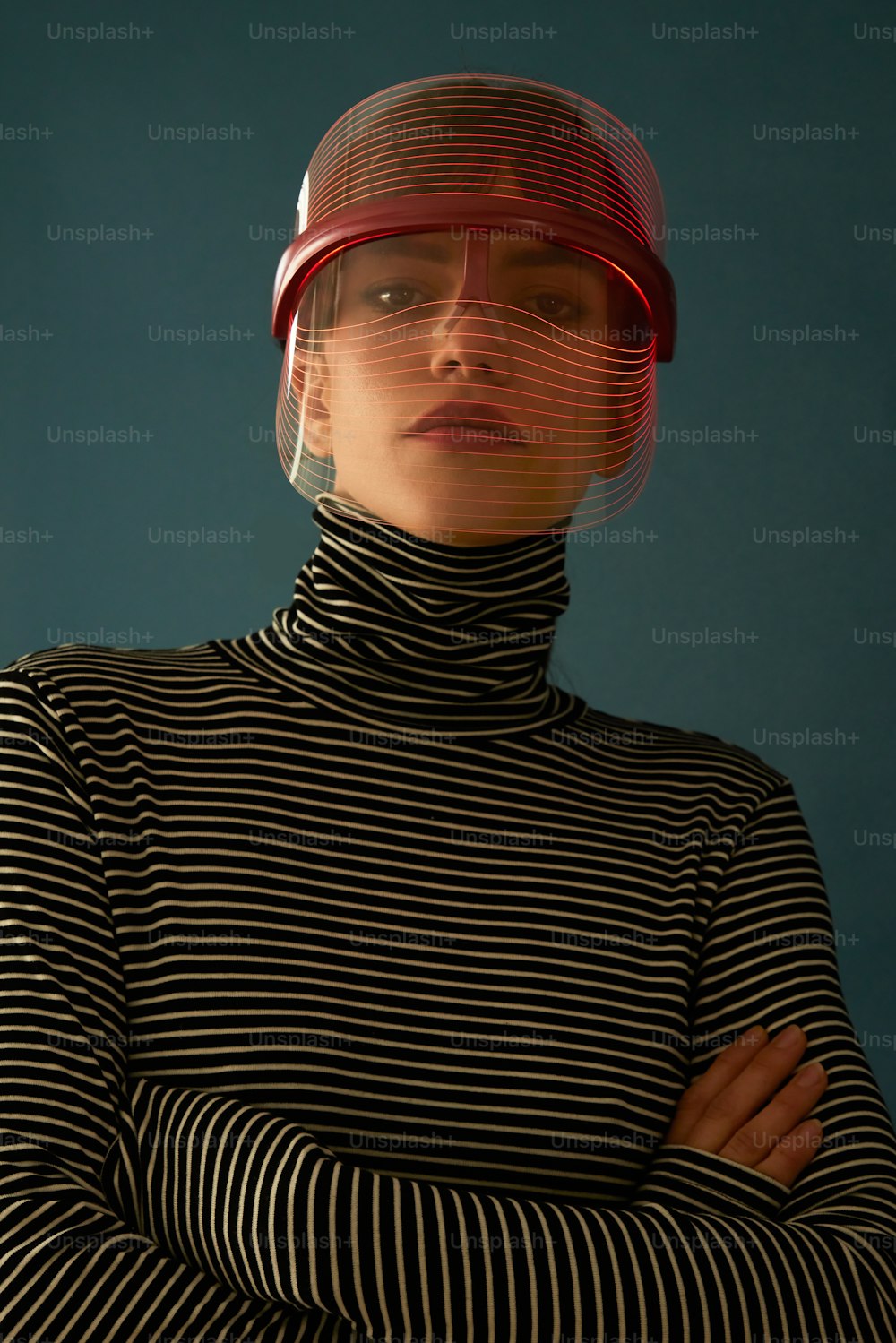 a woman in a black and white striped shirt with a red helmet on her head