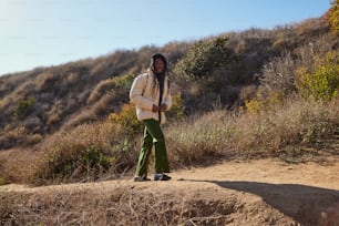 a man standing on top of a dirt hill