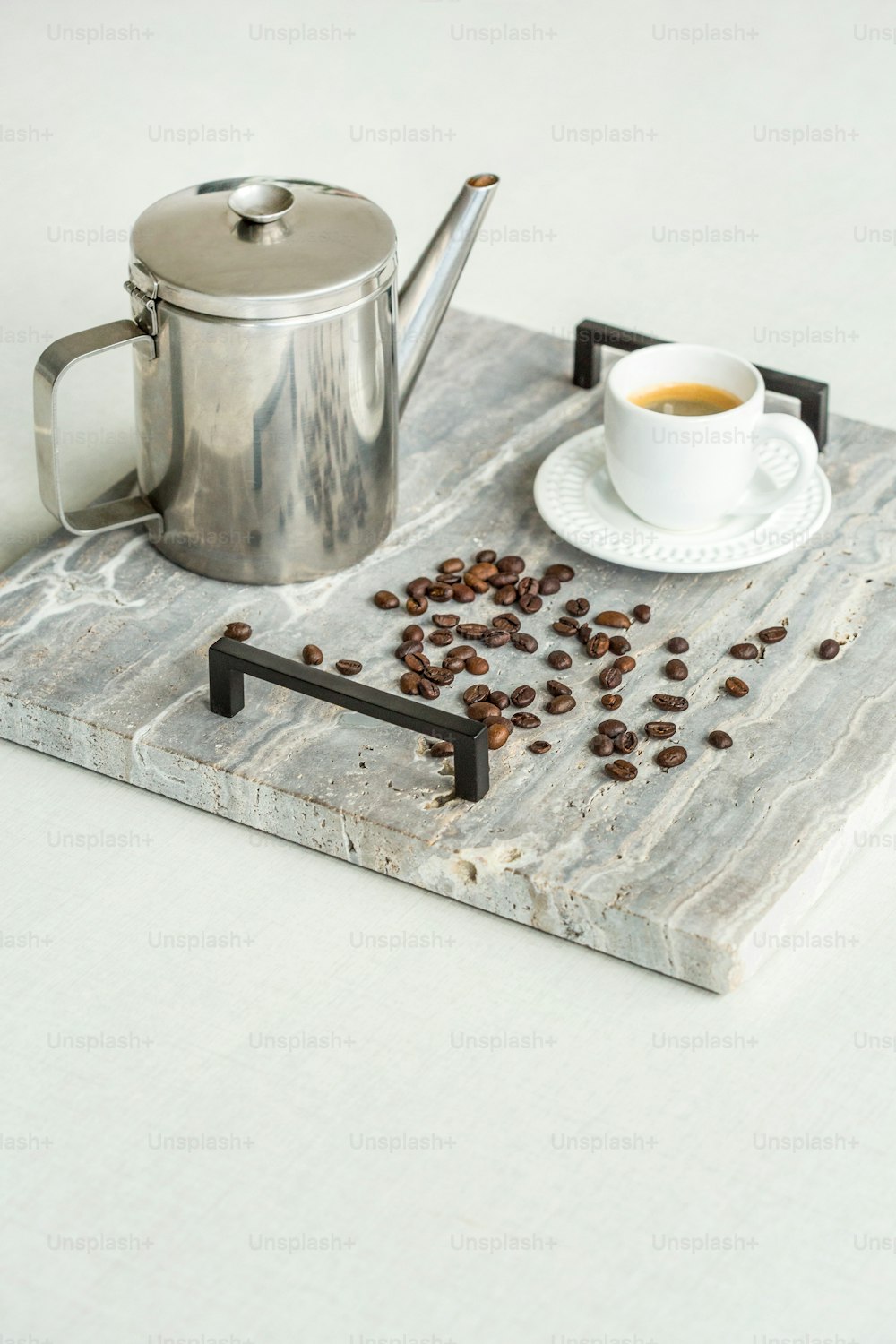 a cup of coffee sitting on top of a wooden tray