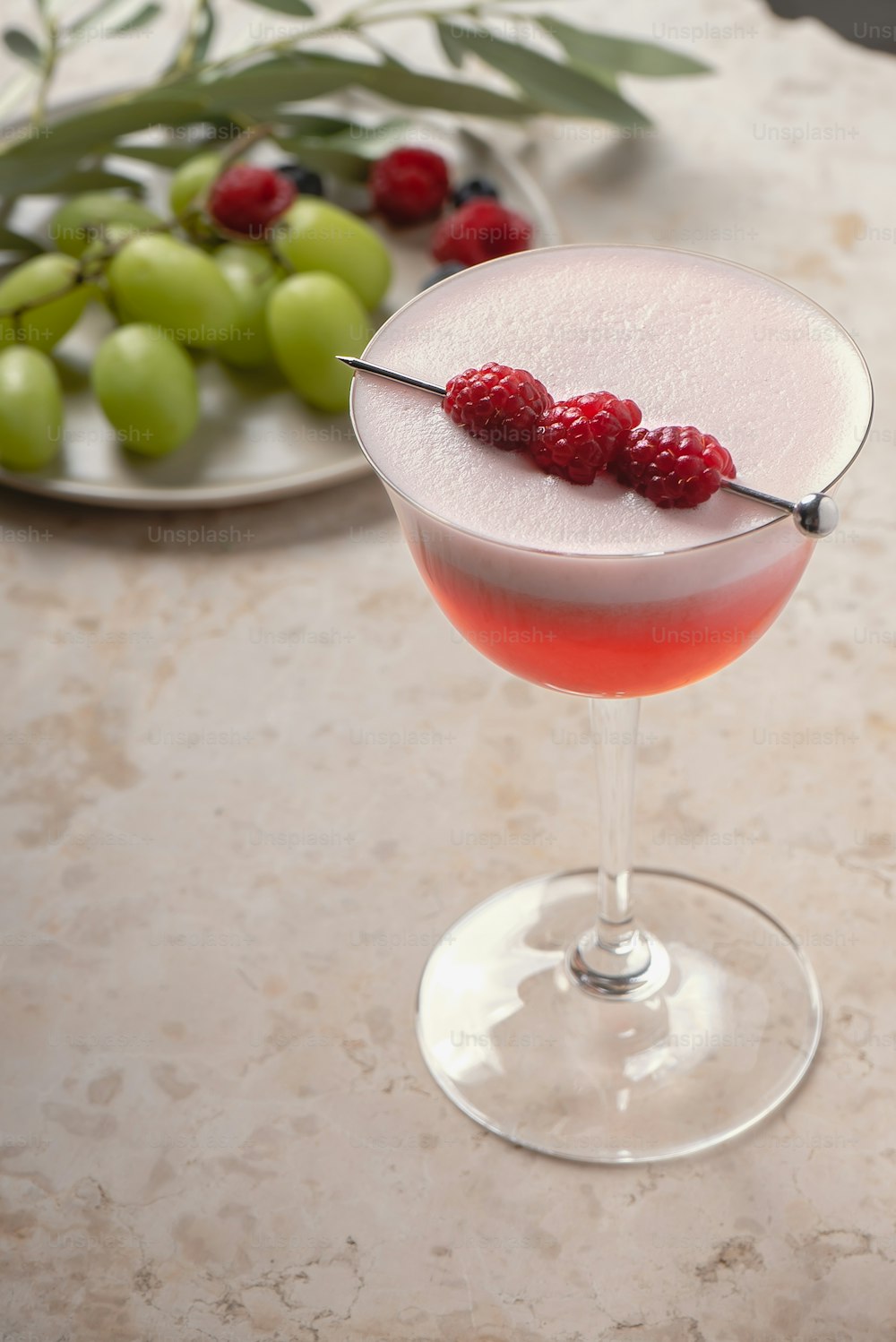 a martini with raspberries on the rim
