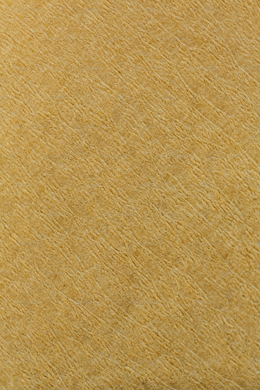 a close up view of a yellow textured surface