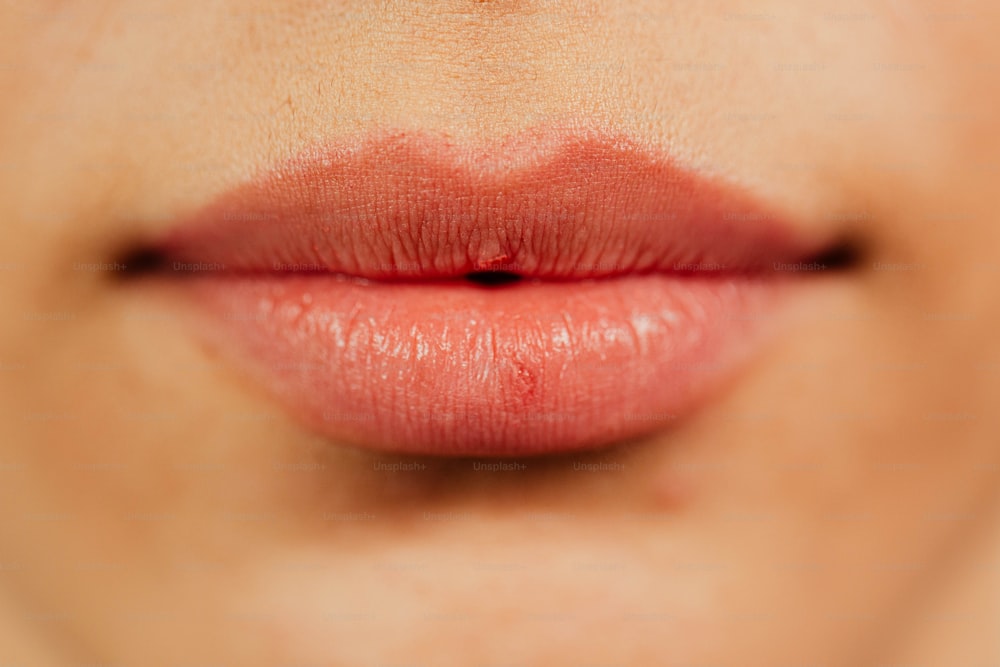 a close up of a woman's lips with red lipstick