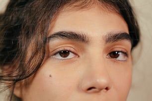 a close up of a woman's face with brown eyes