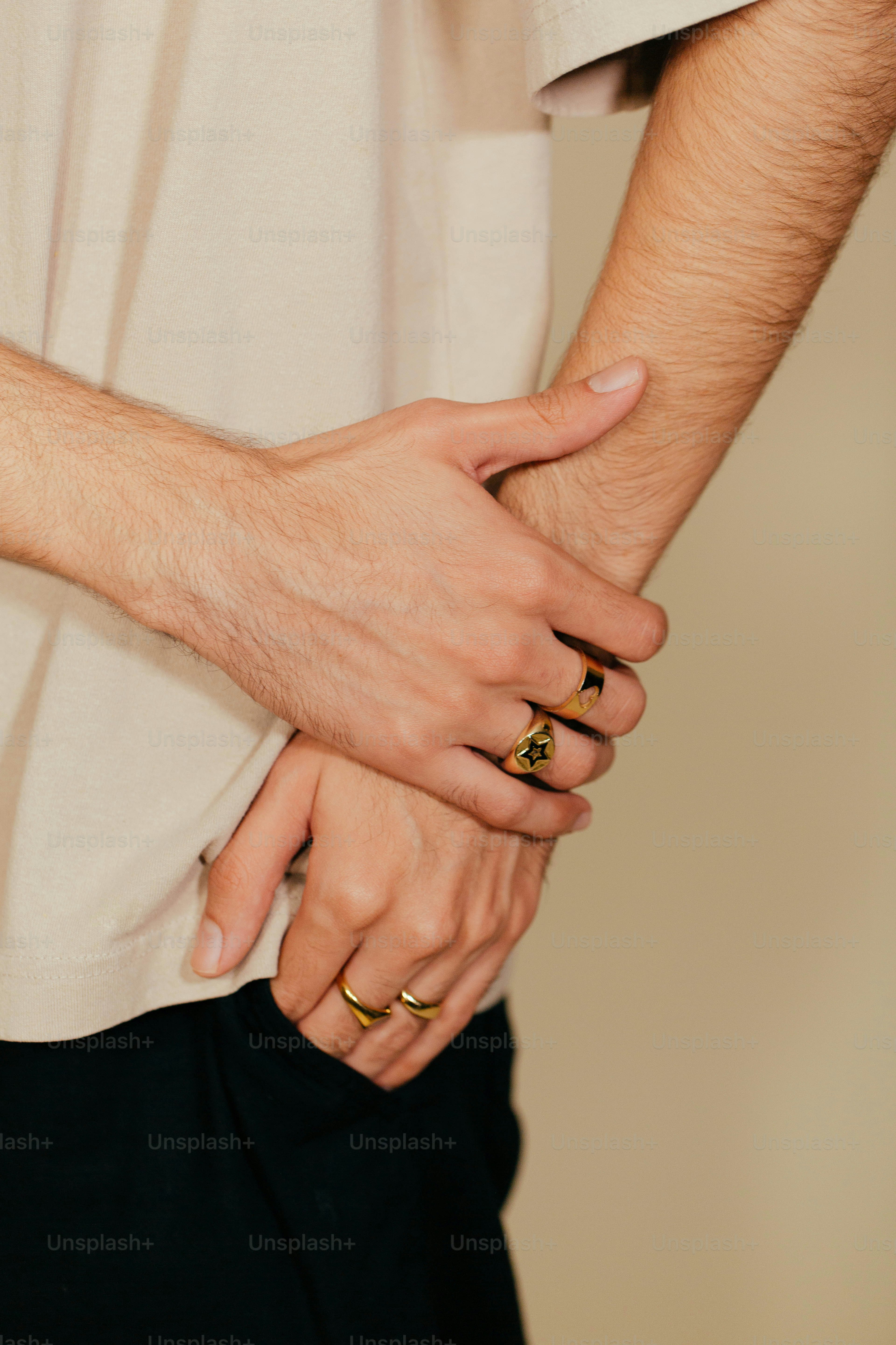 a close up of two people holding hands