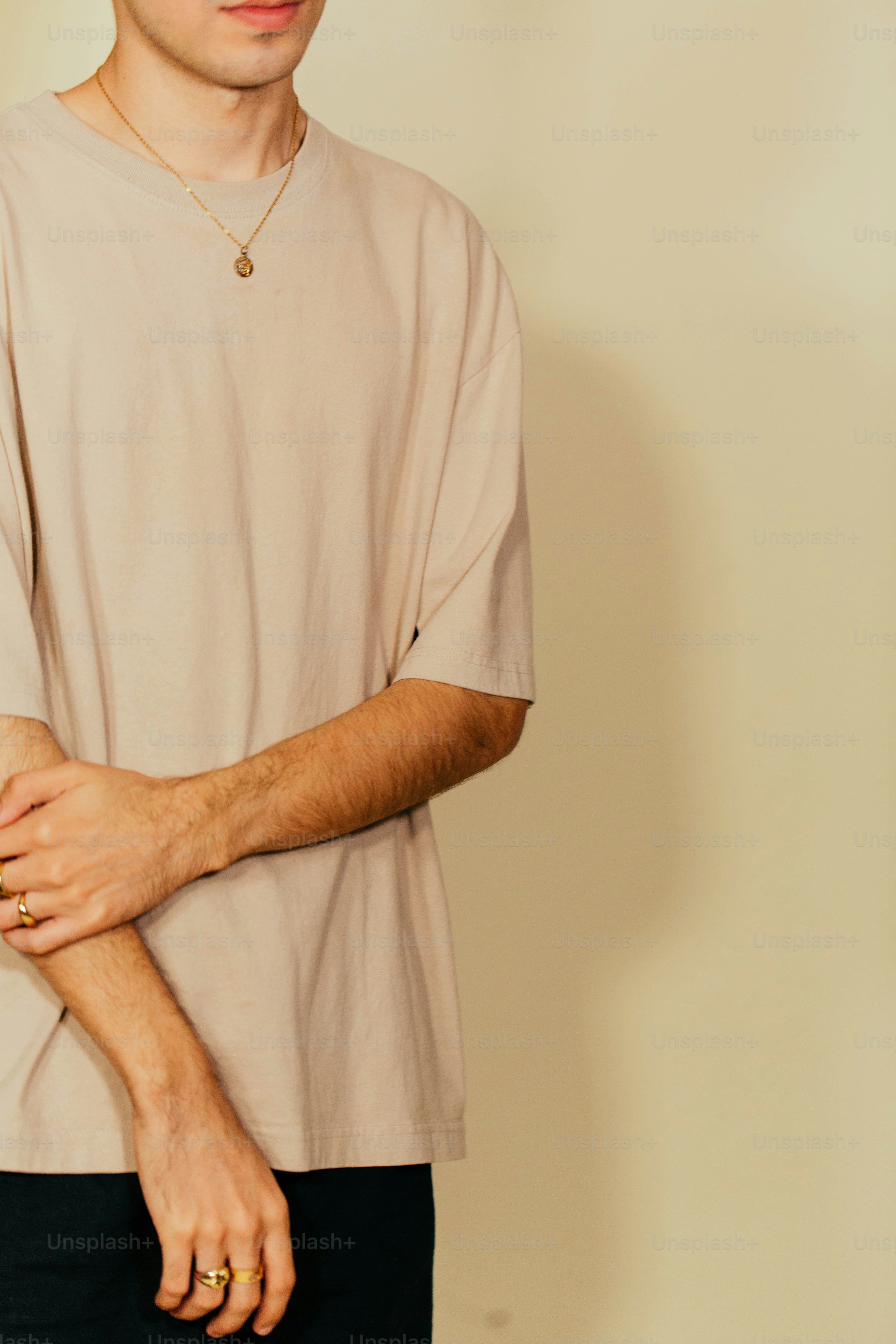 a man in a tan shirt and black pants