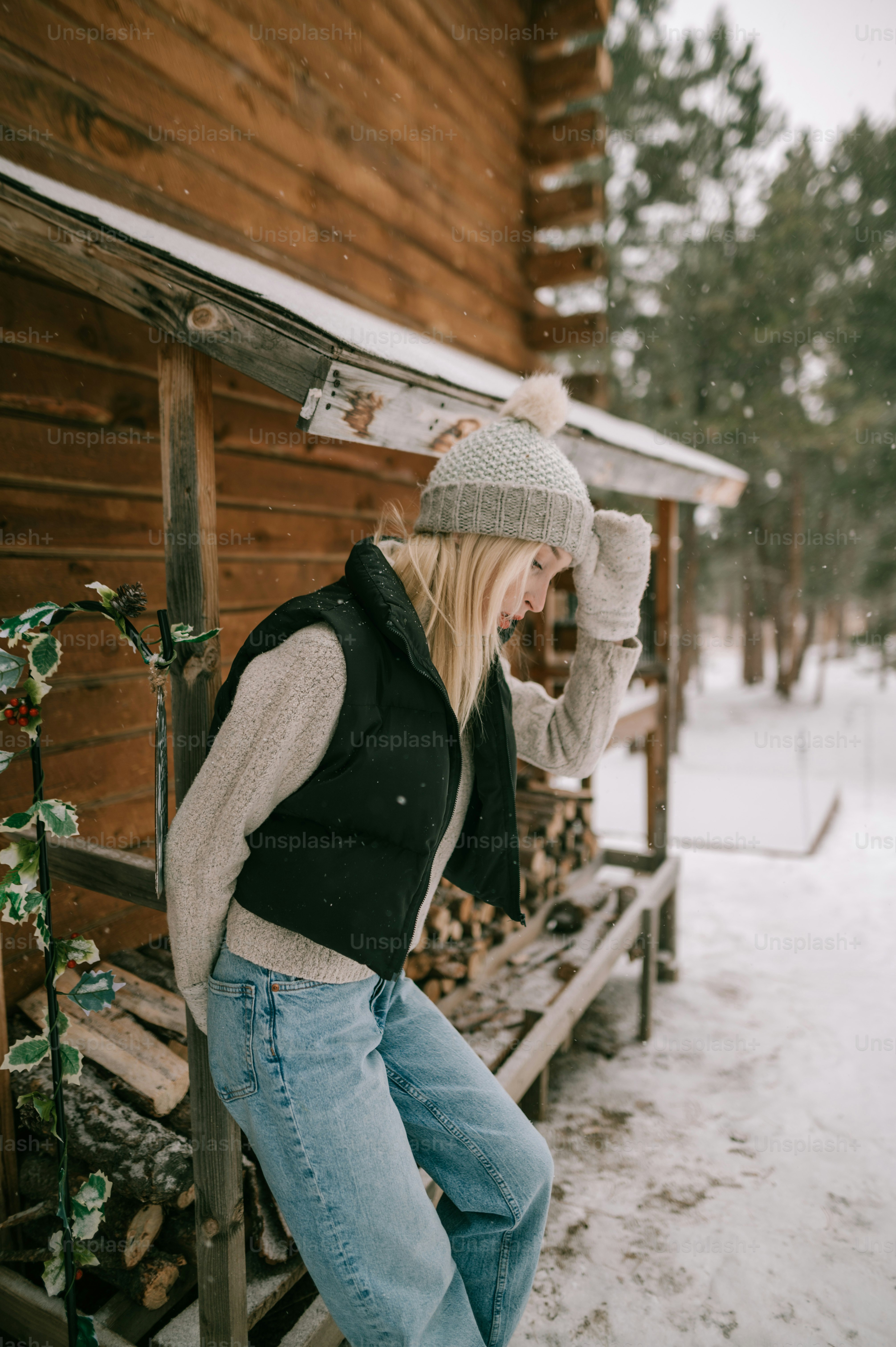 a woman standing on a bench in the snow