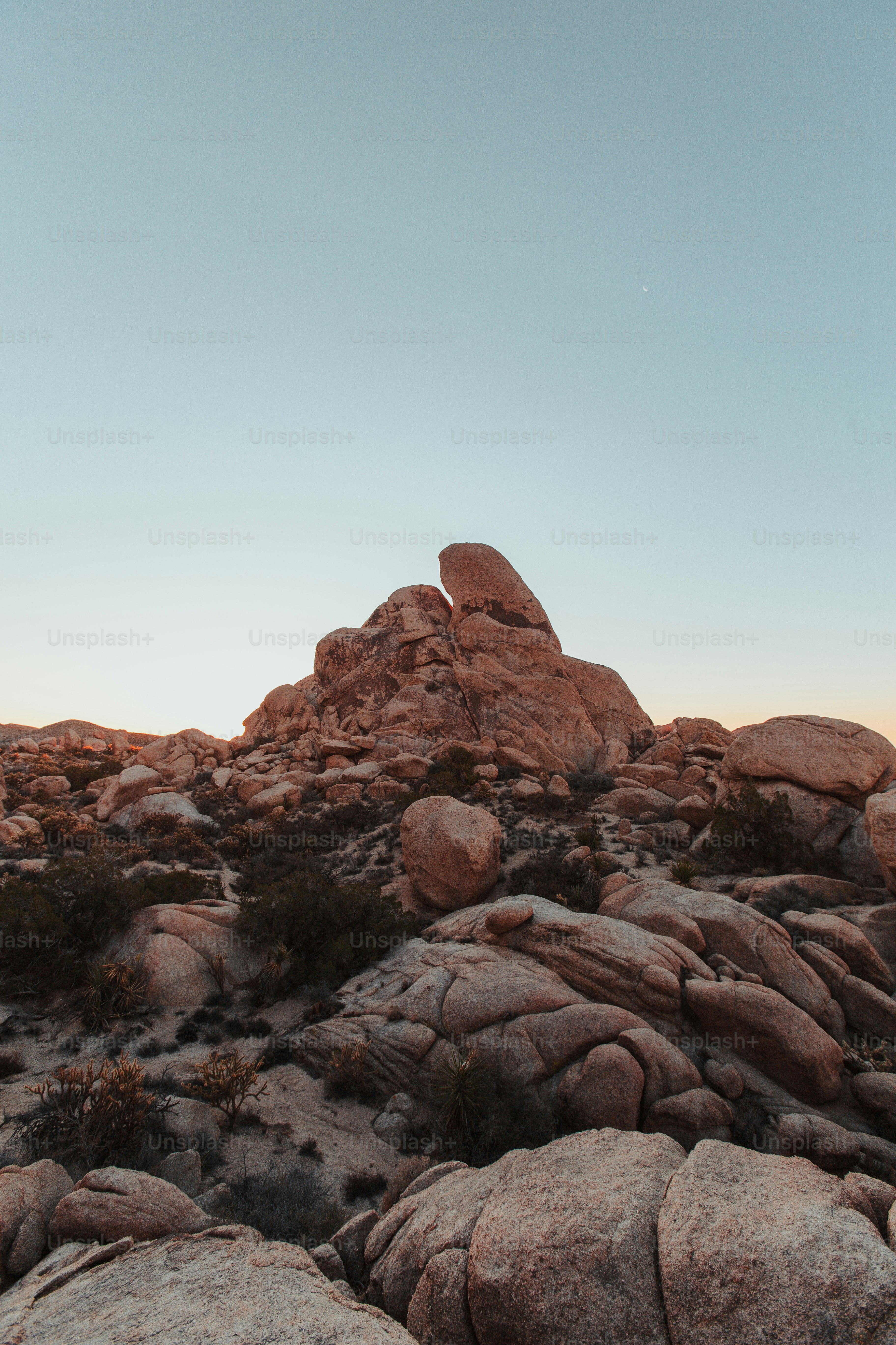 a large rock formation in the middle of a desert