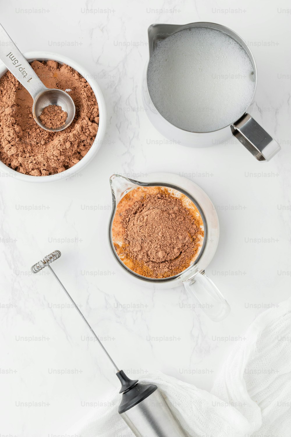 a bowl of chocolate pudding next to a measuring spoon