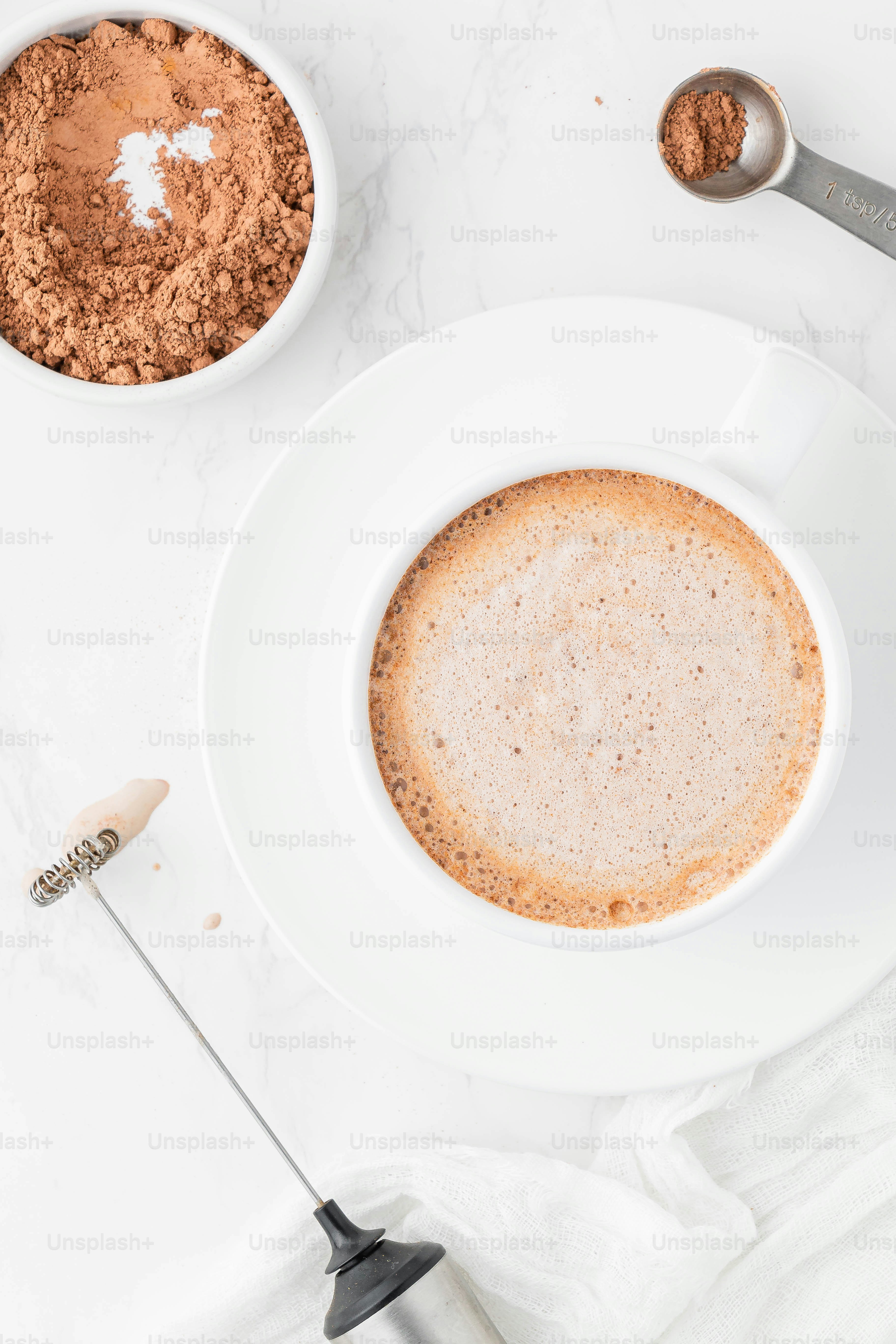 a white plate topped with a cup of coffee