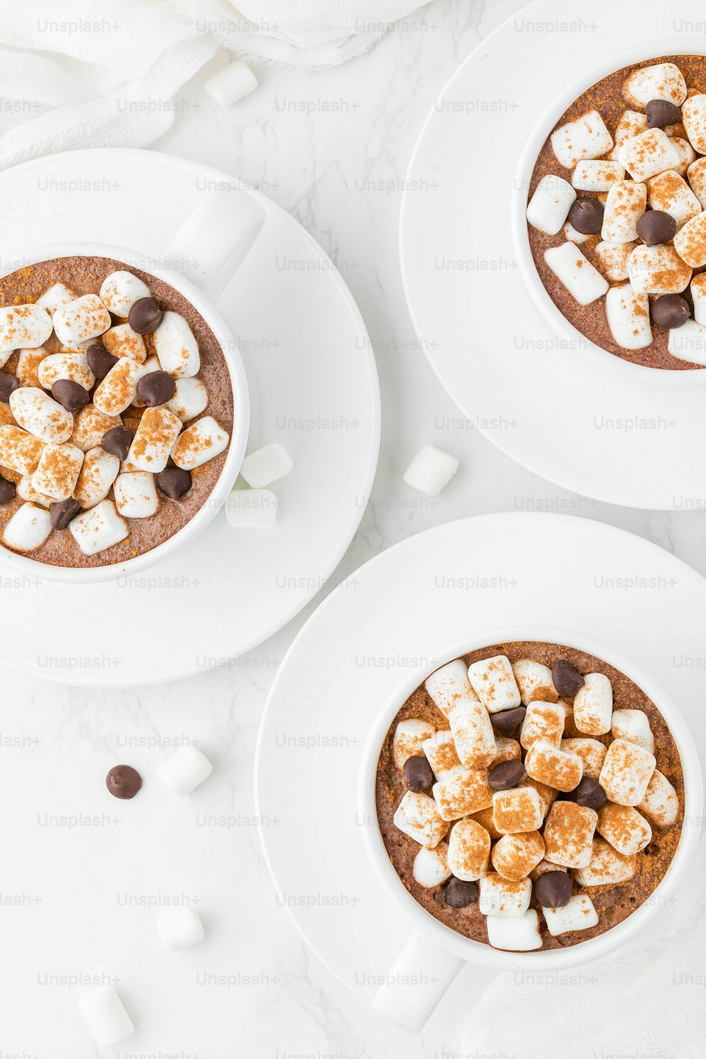 two bowls of hot chocolate with marshmallows in them