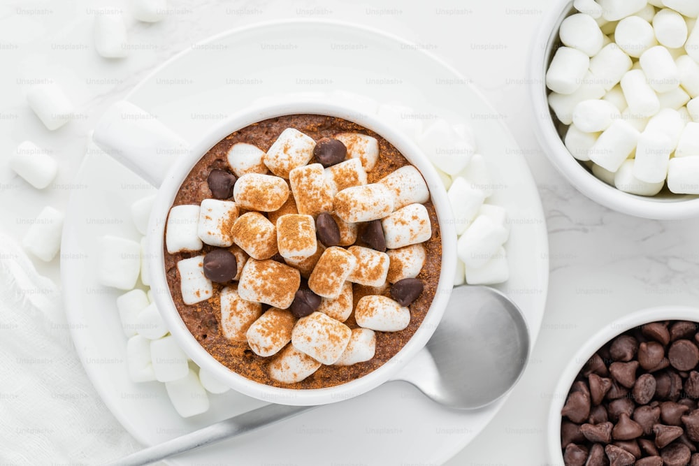 a bowl of hot chocolate with marshmallows and chocolate chips