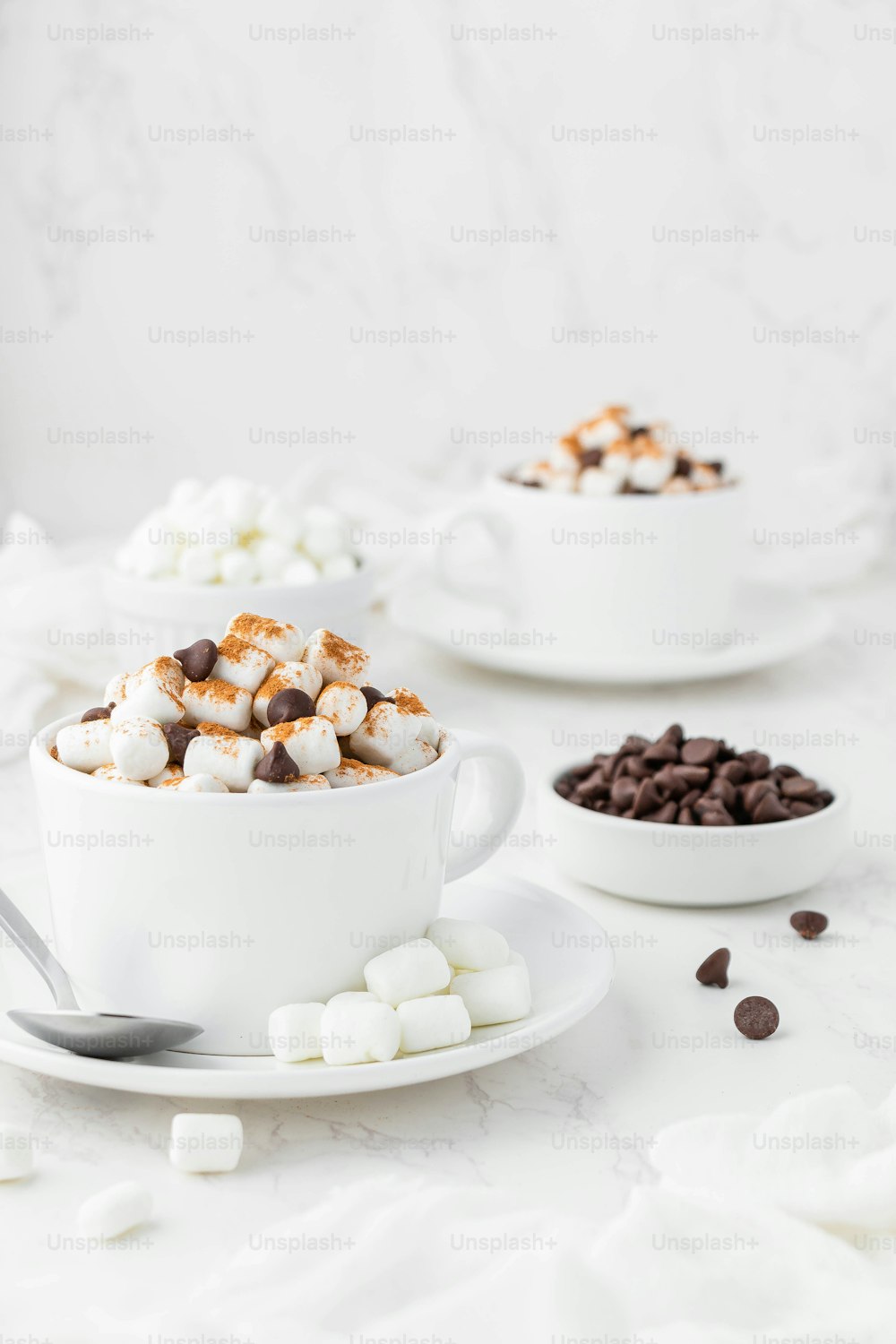 a cup of hot chocolate with marshmallows and chocolate chips