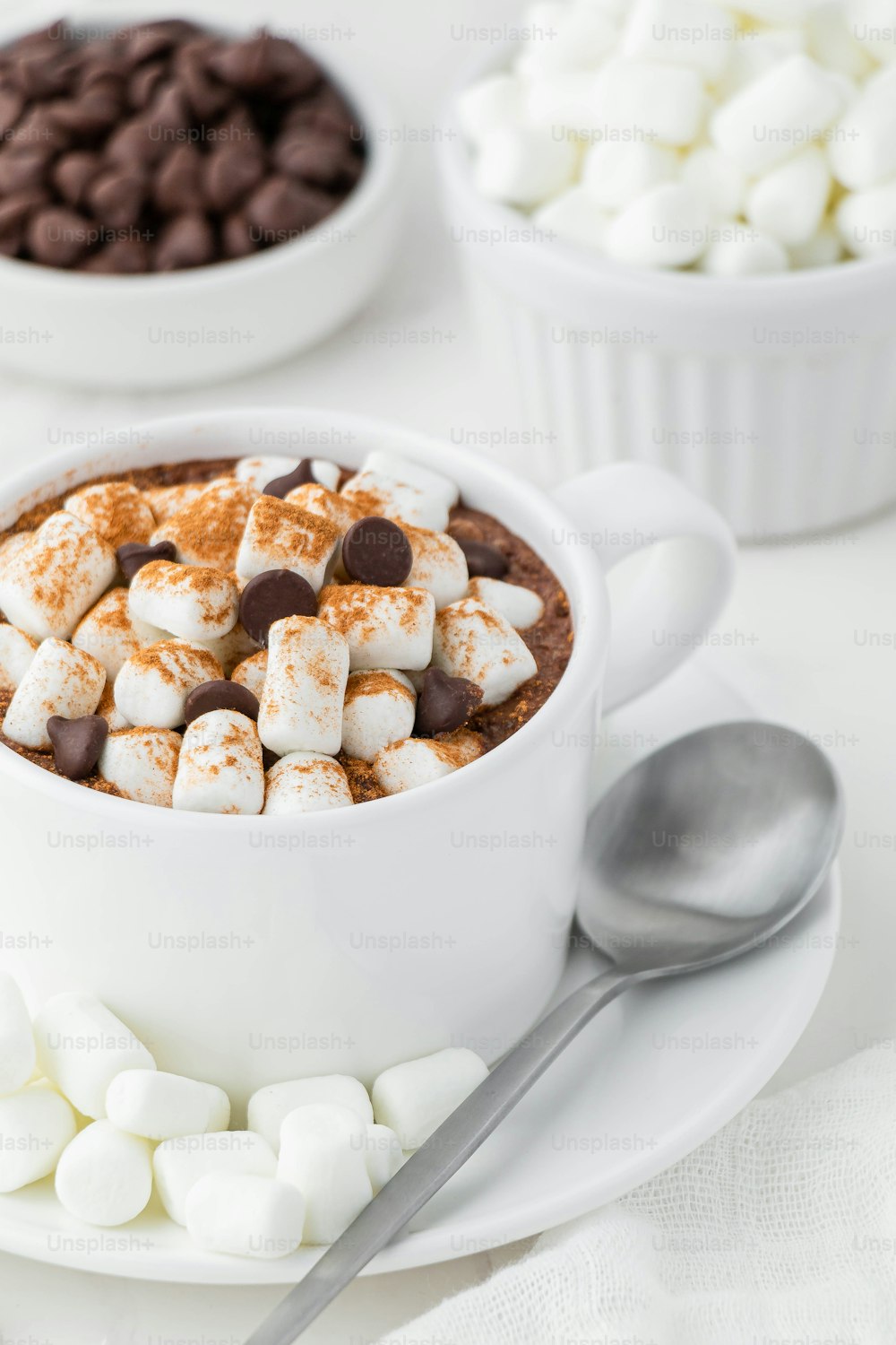 a cup of hot chocolate with marshmallows and chocolate chips