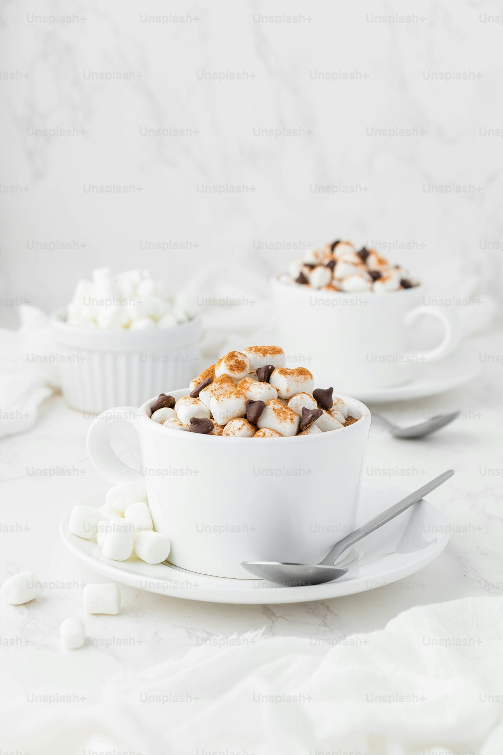 a couple of cups filled with marshmallows