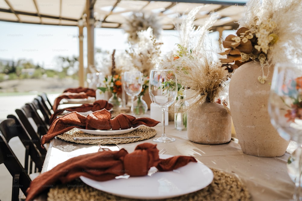 a table set with place settings and flowers