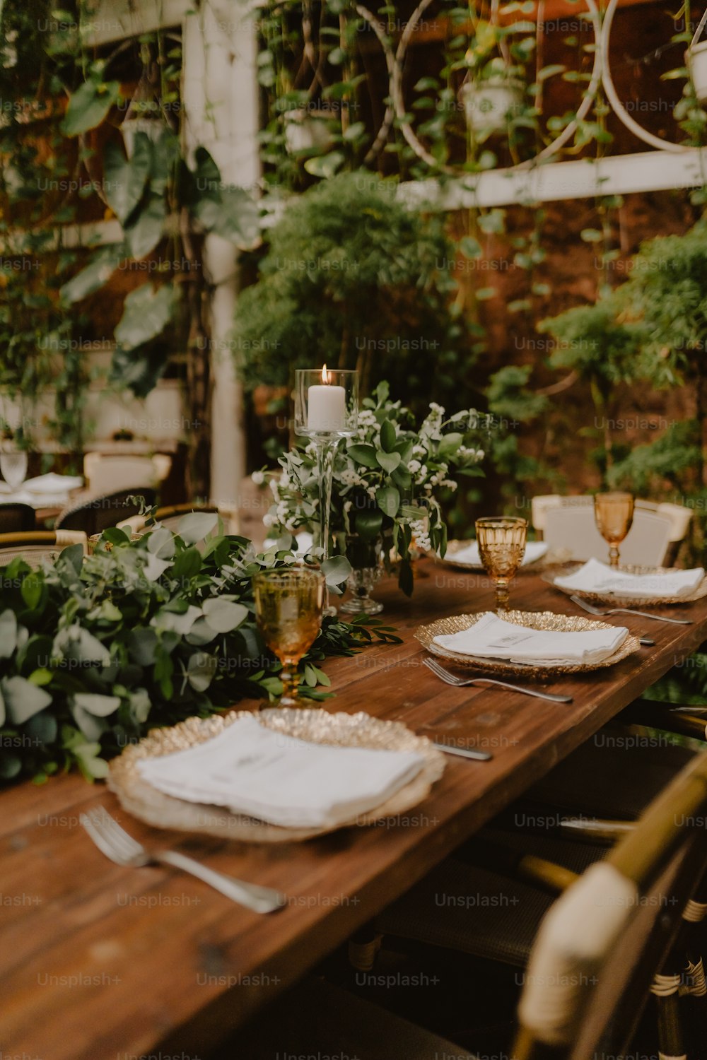 a wooden table topped with plates and glasses