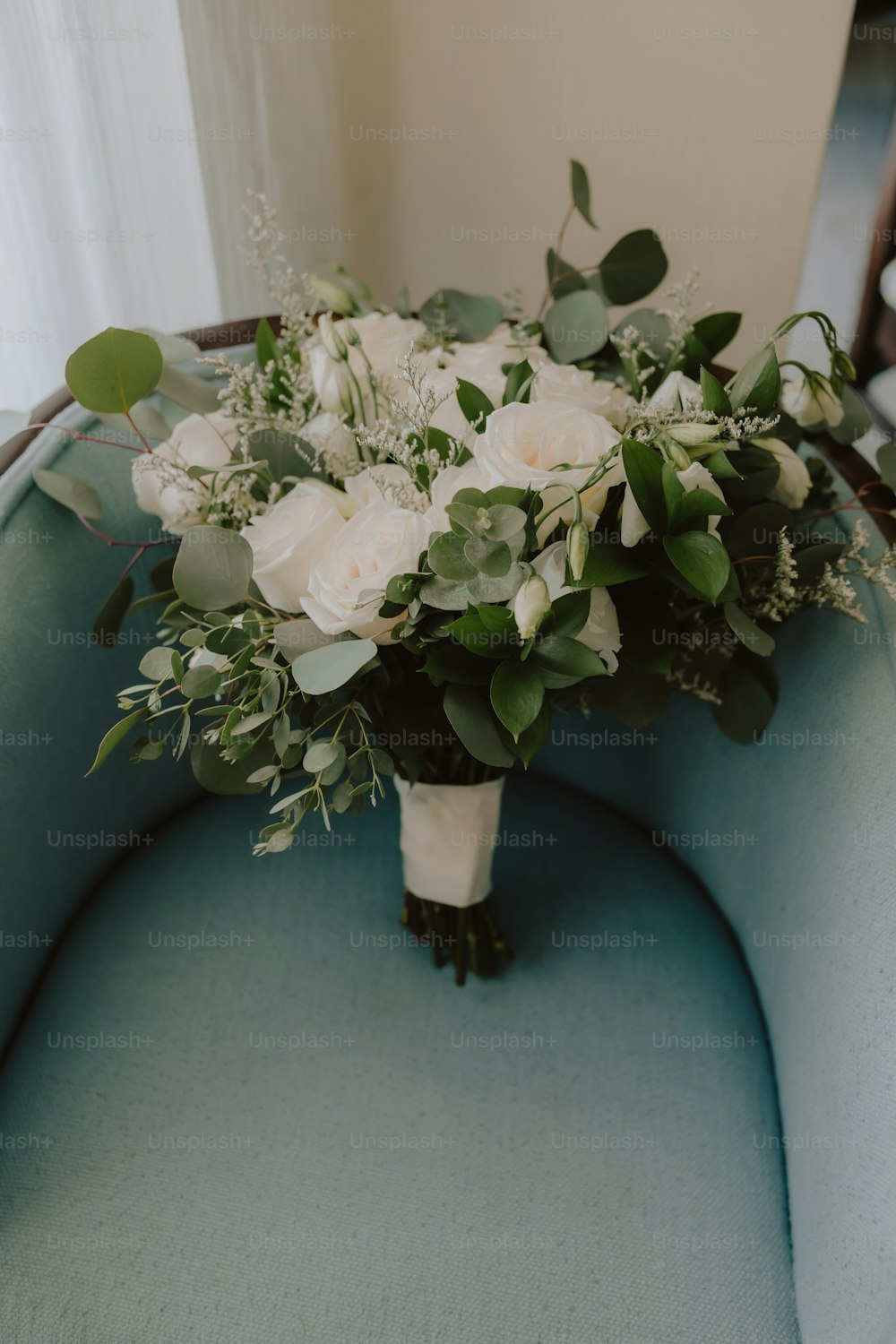 a bouquet of flowers sitting on a blue couch