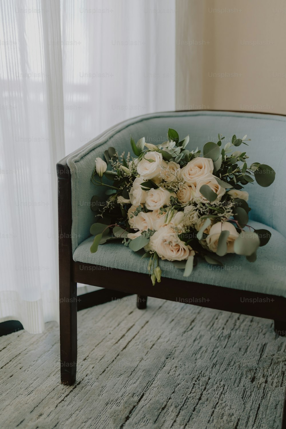 a bouquet of flowers sitting on top of a blue chair