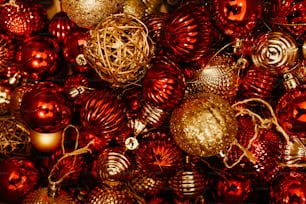 a pile of red and gold christmas ornaments