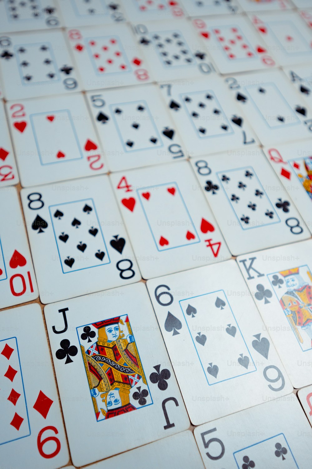 a close up of many playing cards on a table