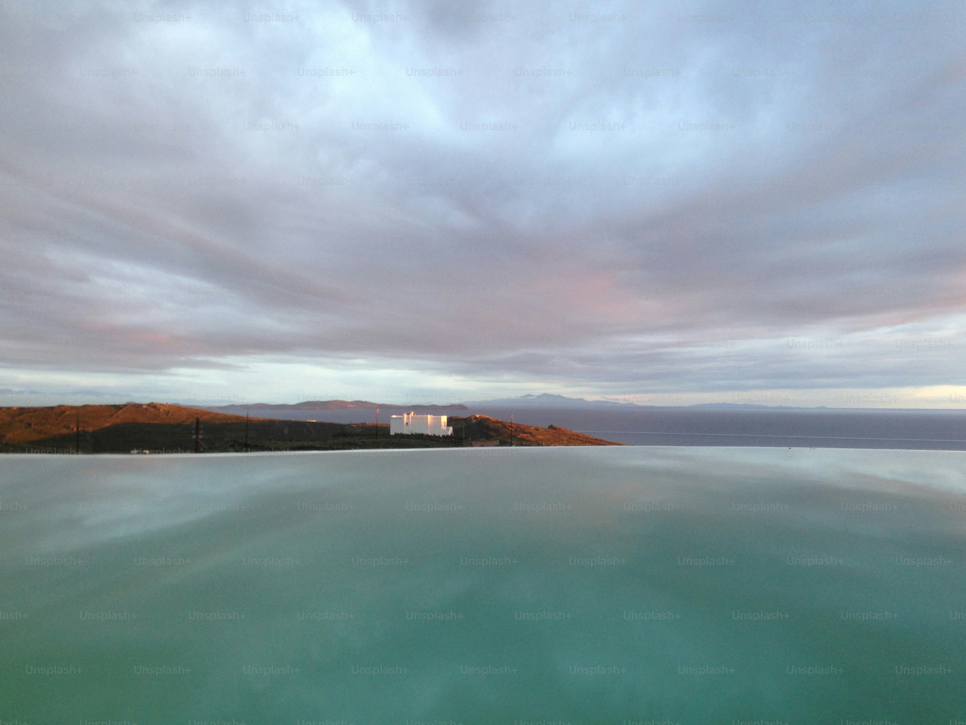 a large body of water under a cloudy sky