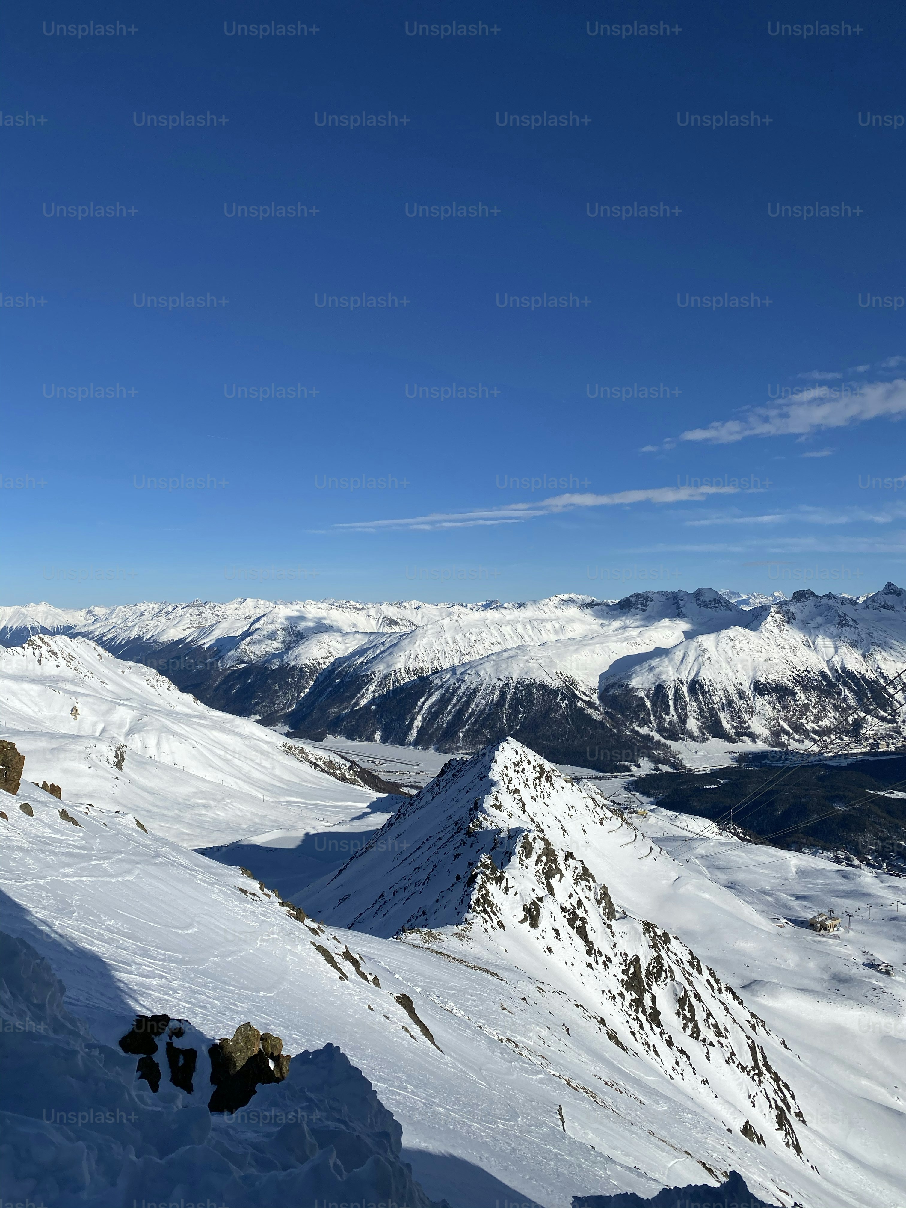 a person standing on top of a snow covered mountain